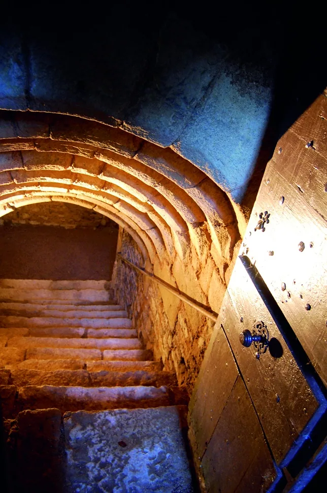 Escalier en pierre et voûtes successives dans les souterrains du château de Couches